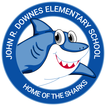 Blue circle white writing John R. Downes Elementary School. Centered blue white shark Home Of The Sharks.